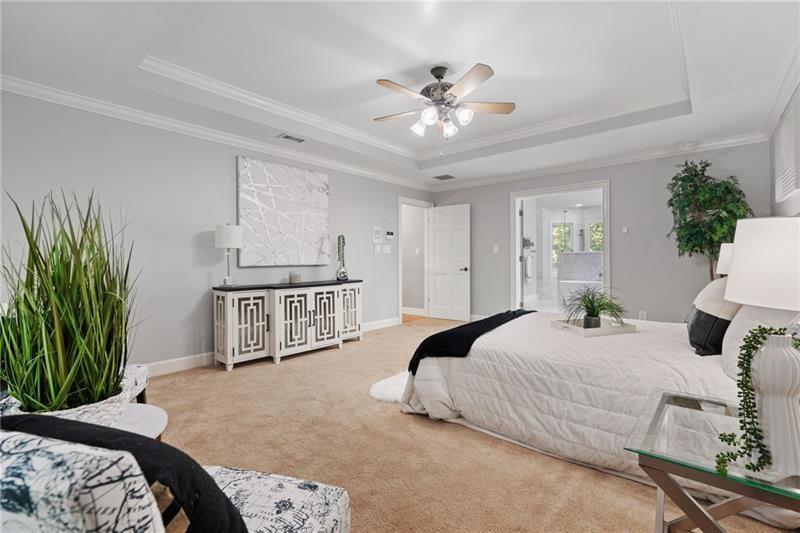 6030 Chimney Springs Road Buford, GA 30518 - Photo 47 of 110 a bedroom with a large bed and a chandelier