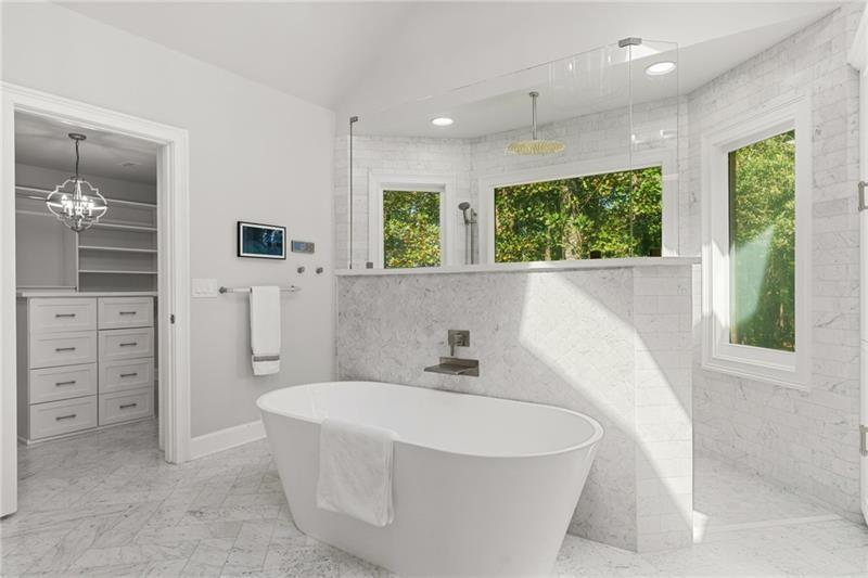 6030 Chimney Springs Road Buford, GA 30518 - Photo 49 of 110 a white bath tub sitting in a en suite bathroom next to a window