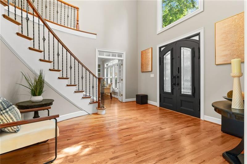 6030 Chimney Springs Road Buford, GA 30518 - Photo 6 of 110 a view of an entryway with wooden floor and a livingroom