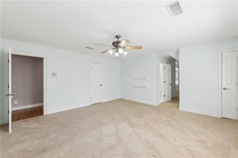 6030 Chimney Springs Road Buford, GA 30518 - Photo 64 of 110 a view of an empty room with a ceiling fan