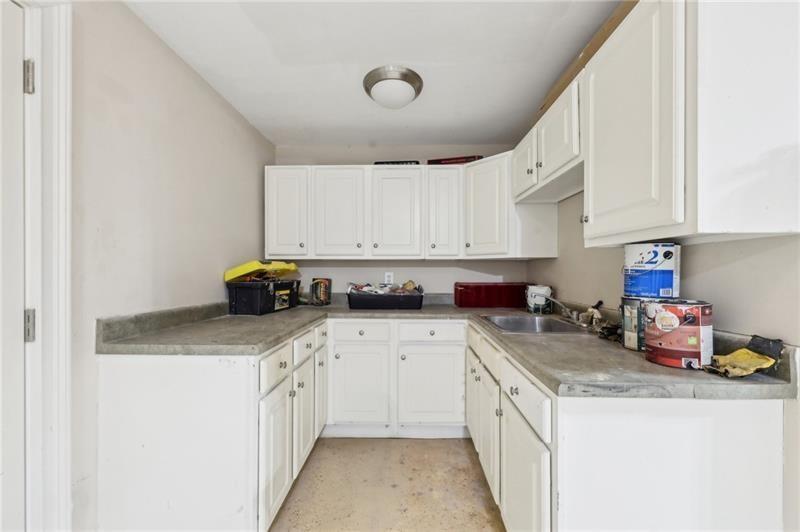 6030 Chimney Springs Road Buford, GA 30518 - Photo 81 of 110 a kitchen with a white cabinets and white appliances