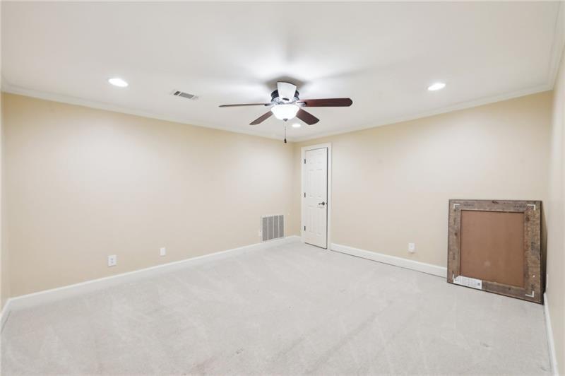 6030 Chimney Springs Road Buford, GA 30518 - Photo 82 of 110 an empty room with a ceiling fan and a window