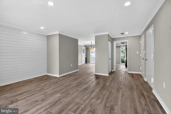 a view of an empty room with wooden floor