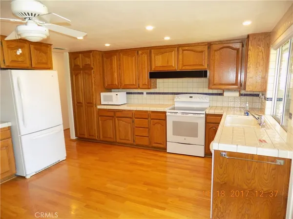 a kitchen with a sink a stove a refrigerator and cabinets