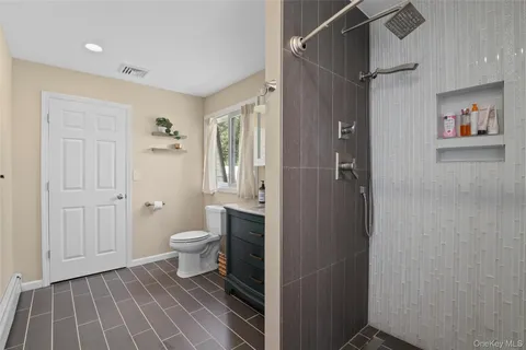 a bathroom with a toilet and a shower