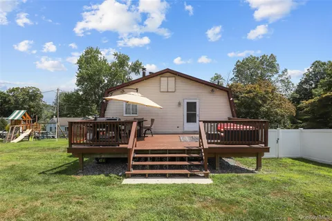 a view of a house with a yard porch and sitting area