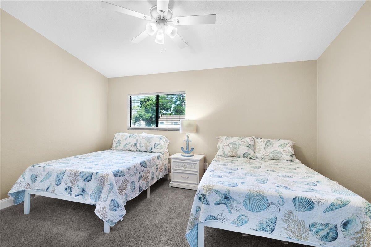 480 Reed Canal Road, Unit 16 Daytona Beach, FL 32119 - Photo 17 of 31 a bedroom with a bed and a window