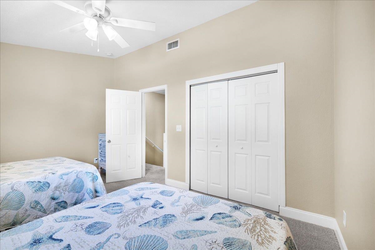 480 Reed Canal Road, Unit 16 Daytona Beach, FL 32119 - Photo 18 of 31 a bedroom with a bed and a chandelier