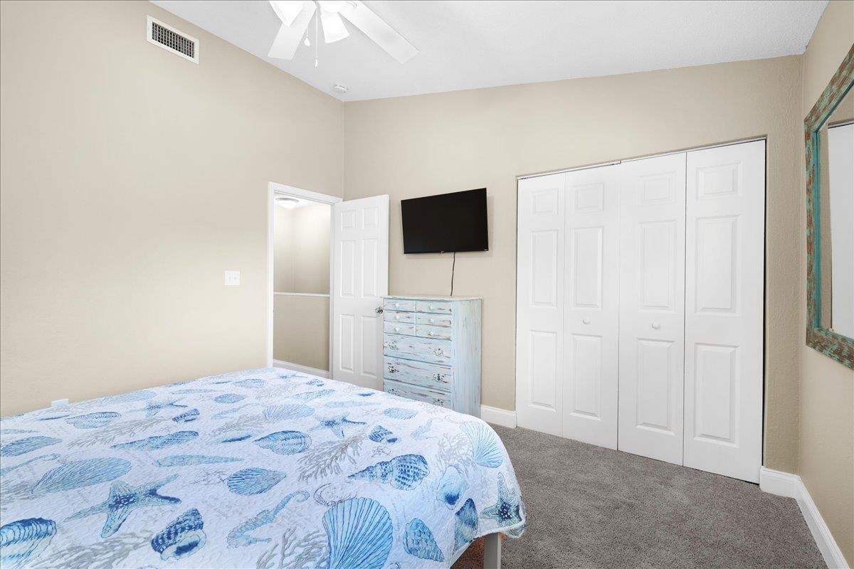 480 Reed Canal Road, Unit 16 Daytona Beach, FL 32119 - Photo 20 of 31 a bedroom with a bed and a flat screen tv