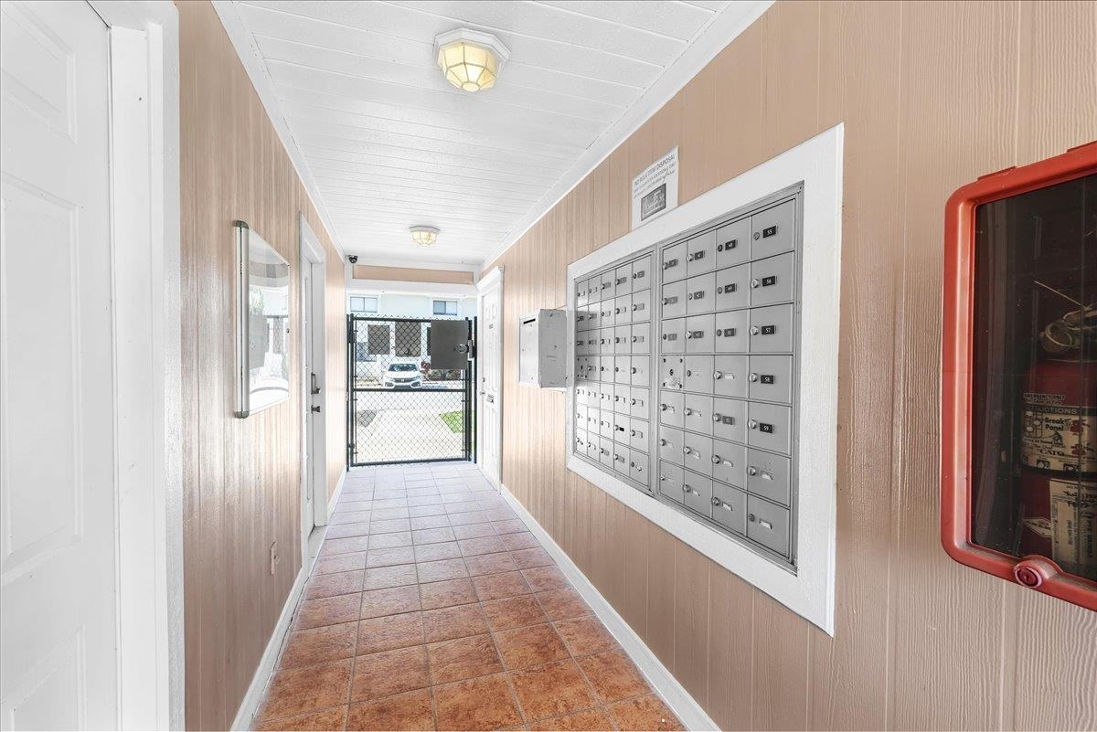 480 Reed Canal Road, Unit 16 Daytona Beach, FL 32119 - Photo 22 of 31 a view of hallway with chandelier and glass door