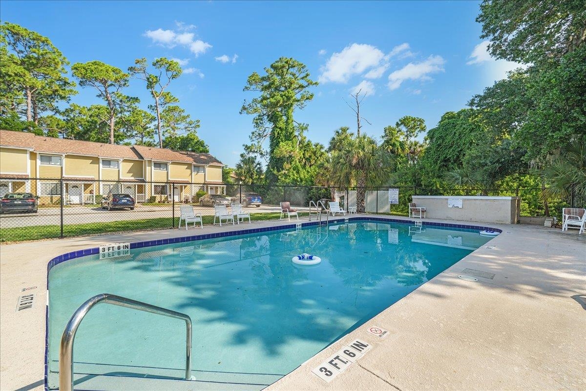 480 Reed Canal Road, Unit 16 Daytona Beach, FL 32119 - Photo 23 of 31 a view of a swimming pool with a lounge chairs