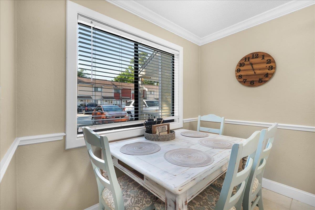 480 Reed Canal Road, Unit 16 Daytona Beach, FL 32119 - Photo 9 of 31 a dining room with furniture and window