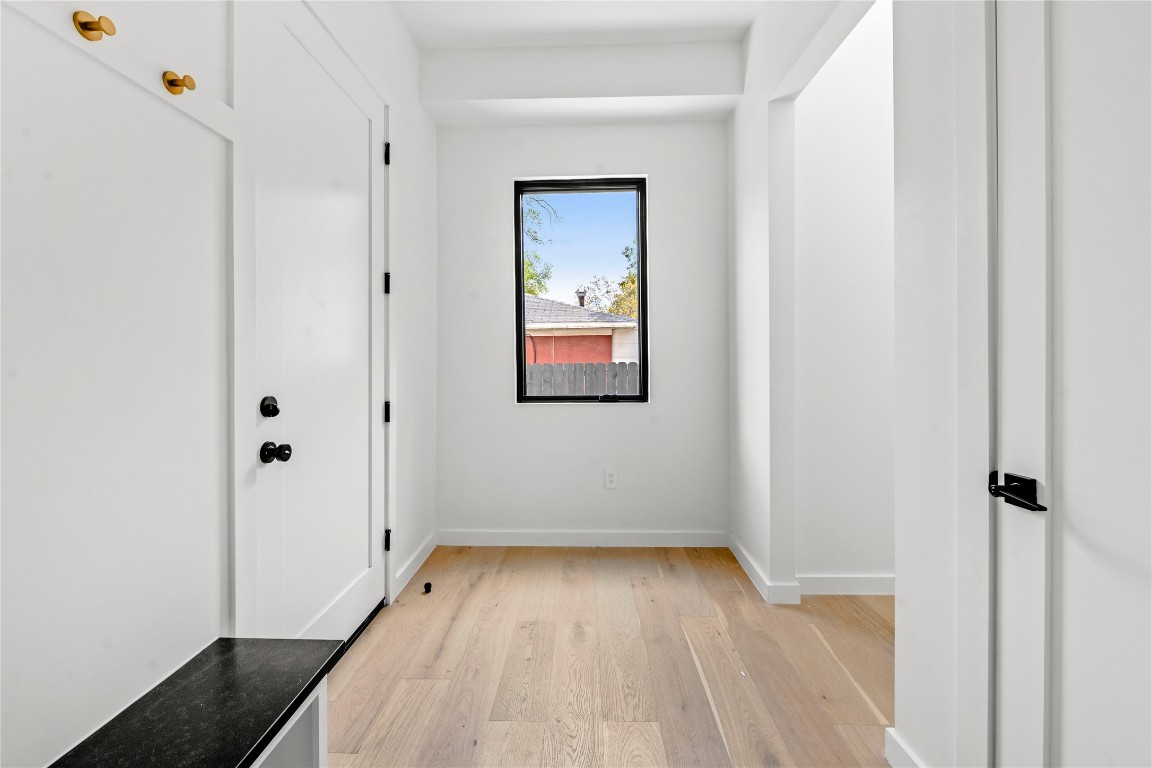 1803 Palo Duro Road Austin, TX 78757 - Photo 28 of 34 Hallway featuring light wood-style flooring and baseboards
