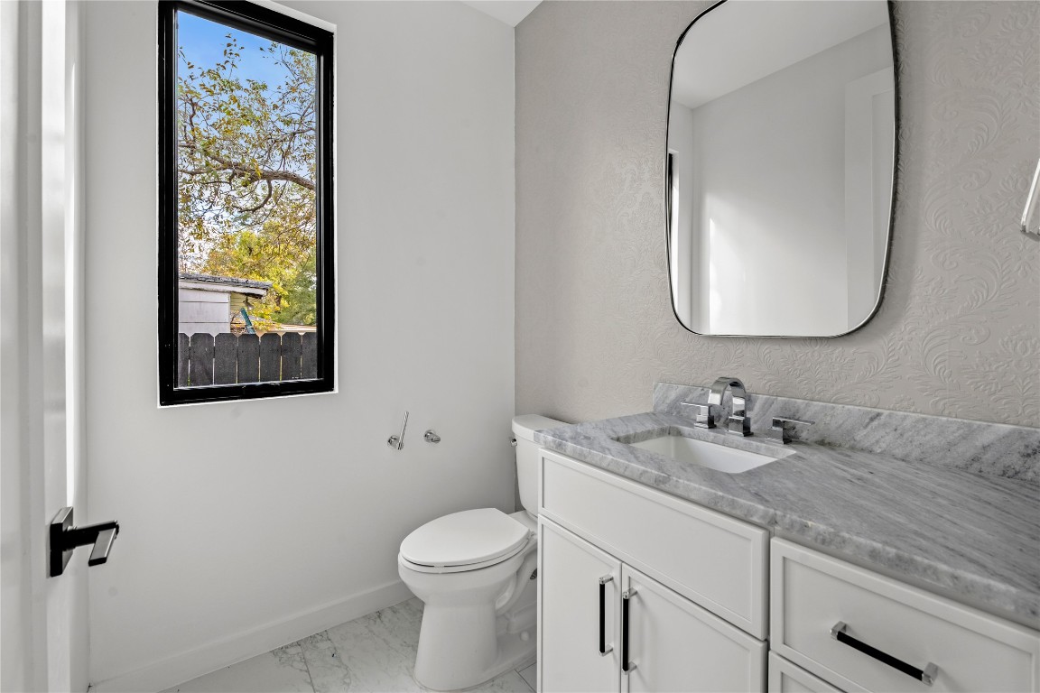 1803 Palo Duro Road Austin, TX 78757 - Photo 29 of 34 Bathroom featuring vanity and light marble finish floors