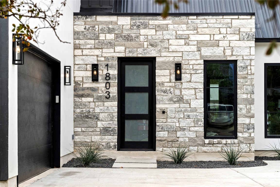 1803 Palo Duro Road Austin, TX 78757 - Photo 3 of 34 View of exterior entry featuring stone siding and elevator