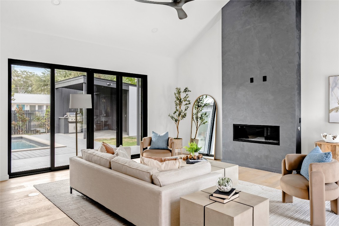 1803 Palo Duro Road Austin, TX 78757 - Photo 5 of 34 Living room featuring light wood-style flooring, a fireplace, a ceiling fan, high vaulted ceiling, and recessed lighting