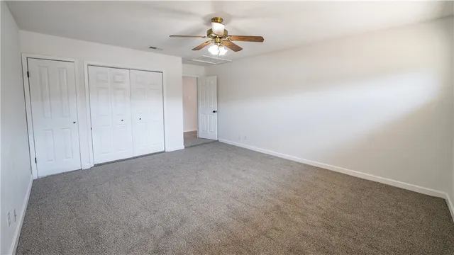 a view of a room with a ceiling fan and a chandelier fan