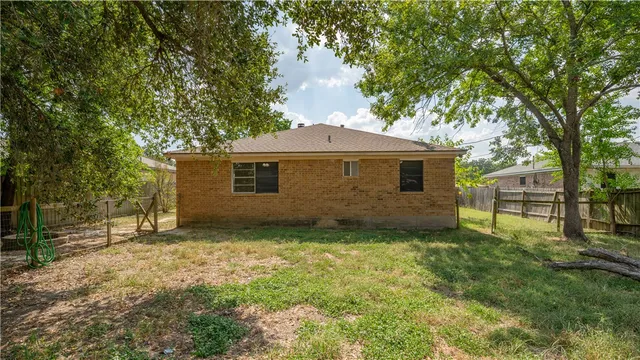 a house is sitting in middle of forest