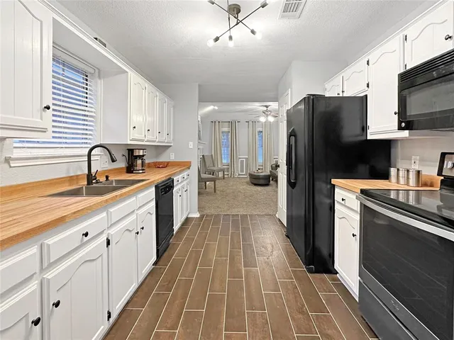 a kitchen with stainless steel appliances a sink stove and refrigerator