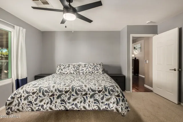 a bedroom with a bed and a window