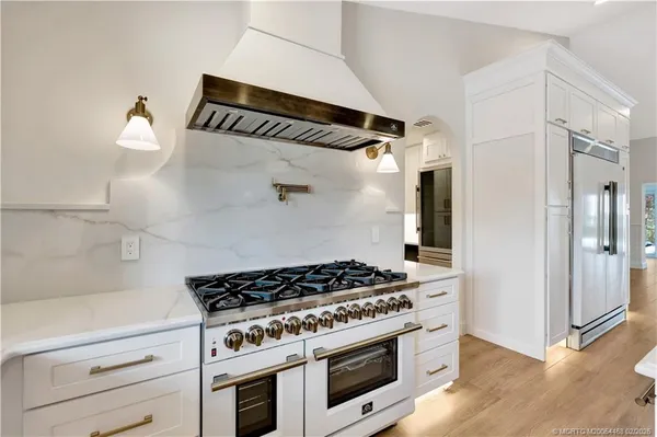 a view of a kitchen with a sink and a large window