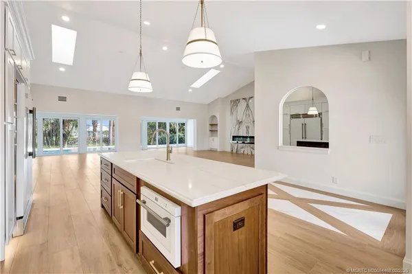 a kitchen with stainless steel appliances granite countertop a refrigerator and a sink
