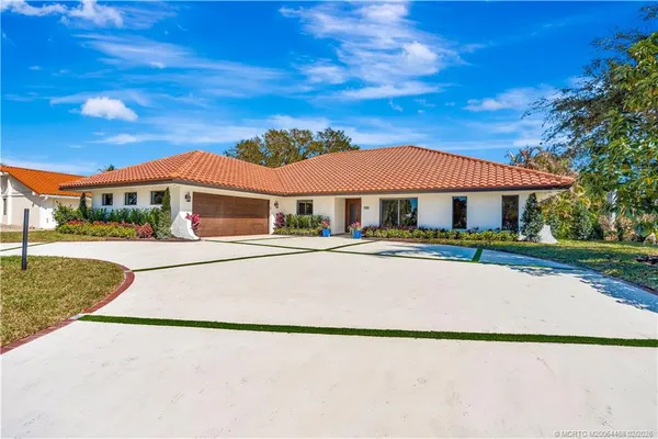 a open kitchen with stainless steel appliances granite countertop a refrigerator a sink dishwasher and a wooden floor