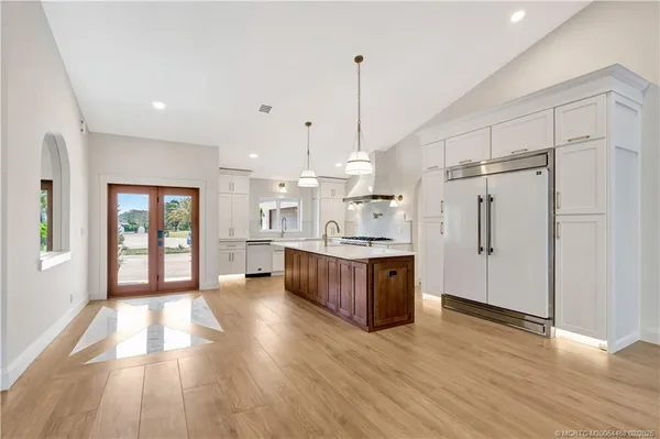 a kitchen with stainless steel appliances granite countertop a stove and a refrigerator