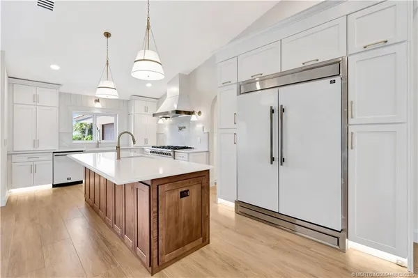 a kitchen with stainless steel appliances a sink and a stove