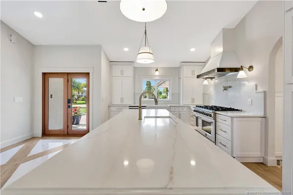 a kitchen with a stove and a wooden floor