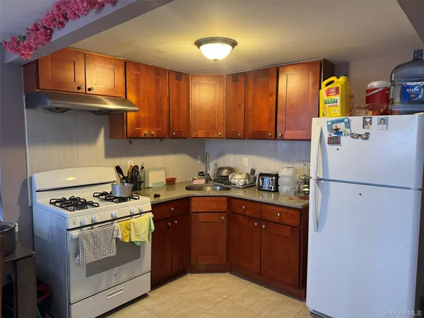 a kitchen with granite countertop a sink stainless steel appliances and cabinets