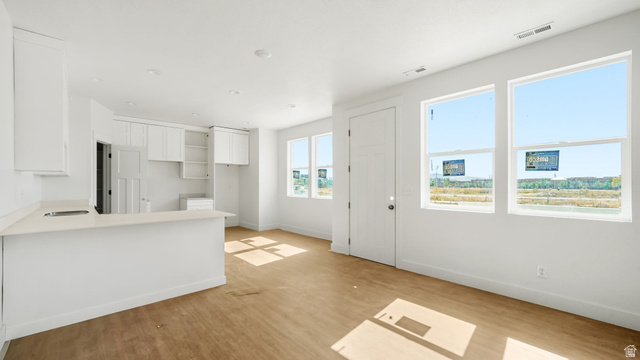 717 South Harrison Drive West Springville, UT 84663 - Photo 6 of 31 Open-concept living area featuring a kitchen with white cabinetry and light-toned countertops, a breakfast bar, and recessed lighting