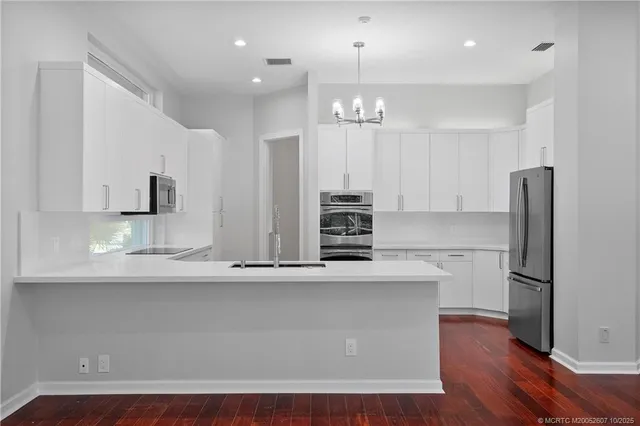 a white bath tub sitting in a bathroom next to a window