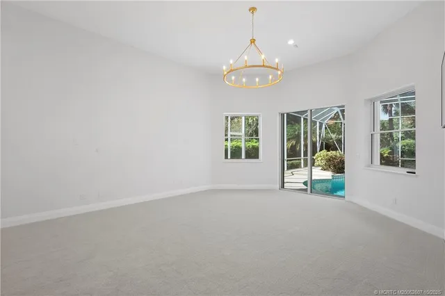 an aerial view of a house with yard and green space
