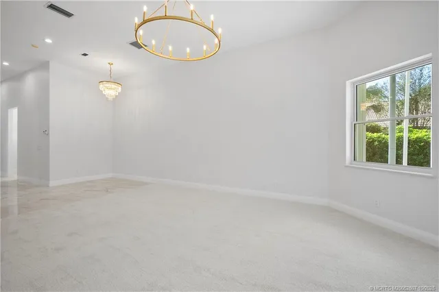 an aerial view of a house with a yard and garden