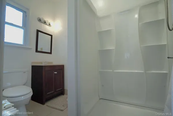 a bathroom with a toilet sink vanity and mirror