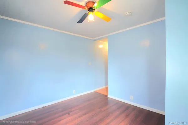a view of an empty room with wooden floor and windows