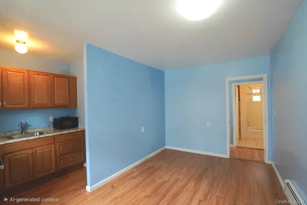 a view of a kitchen with wooden floor and electronic appliances