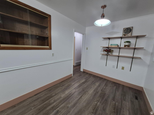 722 Adams Street Montpelier, ID 83254 - Photo 7 of 22 Unfurnished dining area featuring dark wood-type flooring and baseboards
