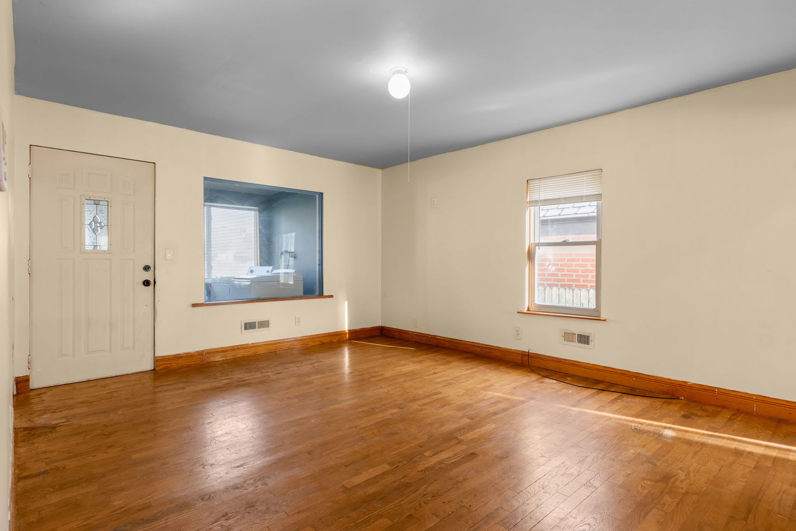1528 North 39th Avenue Stone Park, IL 60165 - Photo 11 of 16 an empty room with wooden floor and windows