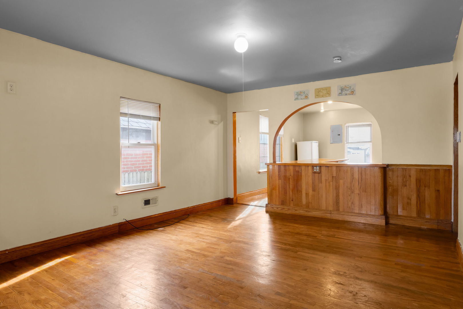 1528 North 39th Avenue Stone Park, IL 60165 - Photo 2 of 16 an empty room with wooden floor and windows