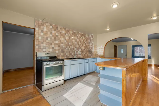 a kitchen with stainless steel appliances granite countertop a stove and a sink
