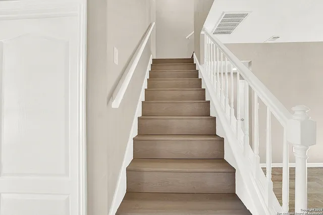 a bathroom with a granite countertop tub sink and mirror