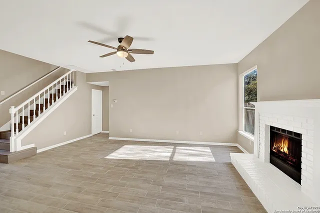an empty room with windows and outdoor view