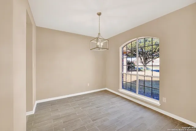 a kitchen with granite countertop white cabinets and stainless steel appliances