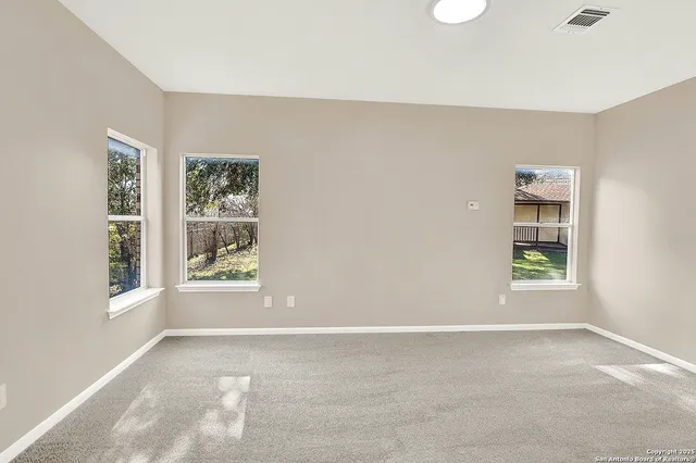 a bathroom with a granite countertop sink a mirror and a shower