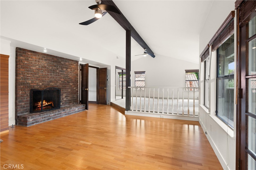 24692 Kings Road Laguna Niguel, CA 92677 - Photo 13 of 39 a view of an empty room with wooden floor and a fireplace