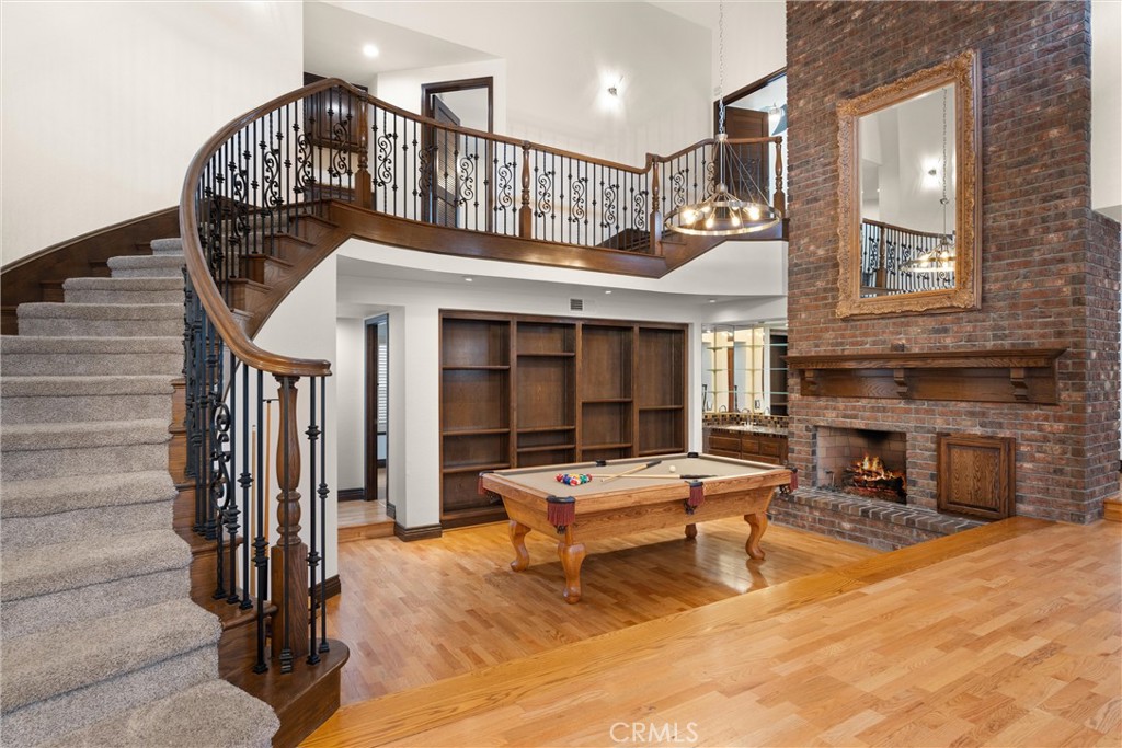 24692 Kings Road Laguna Niguel, CA 92677 - Photo 2 of 39 a living room with furniture a fireplace and lots of windows