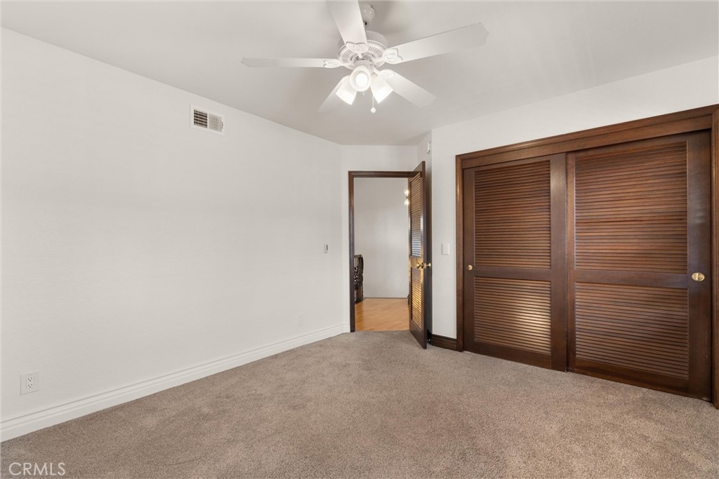 24692 Kings Road Laguna Niguel, CA 92677 - Photo 25 of 39 a view of an empty room with closet and a ceiling fan