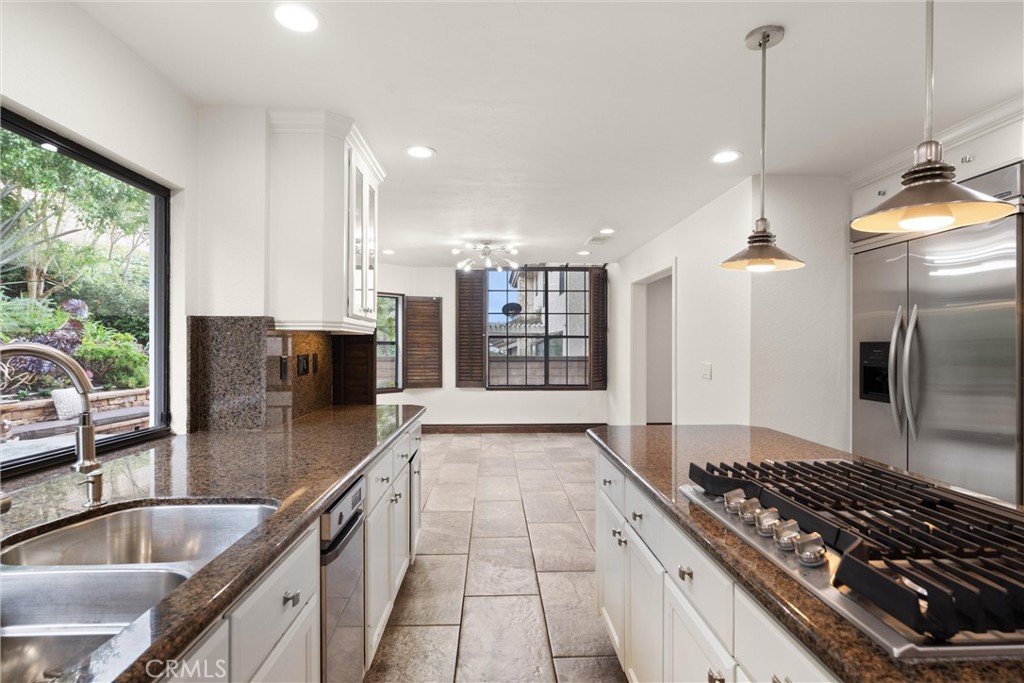 24692 Kings Road Laguna Niguel, CA 92677 - Photo 9 of 39 a kitchen with stainless steel appliances granite countertop a sink stove and refrigerator